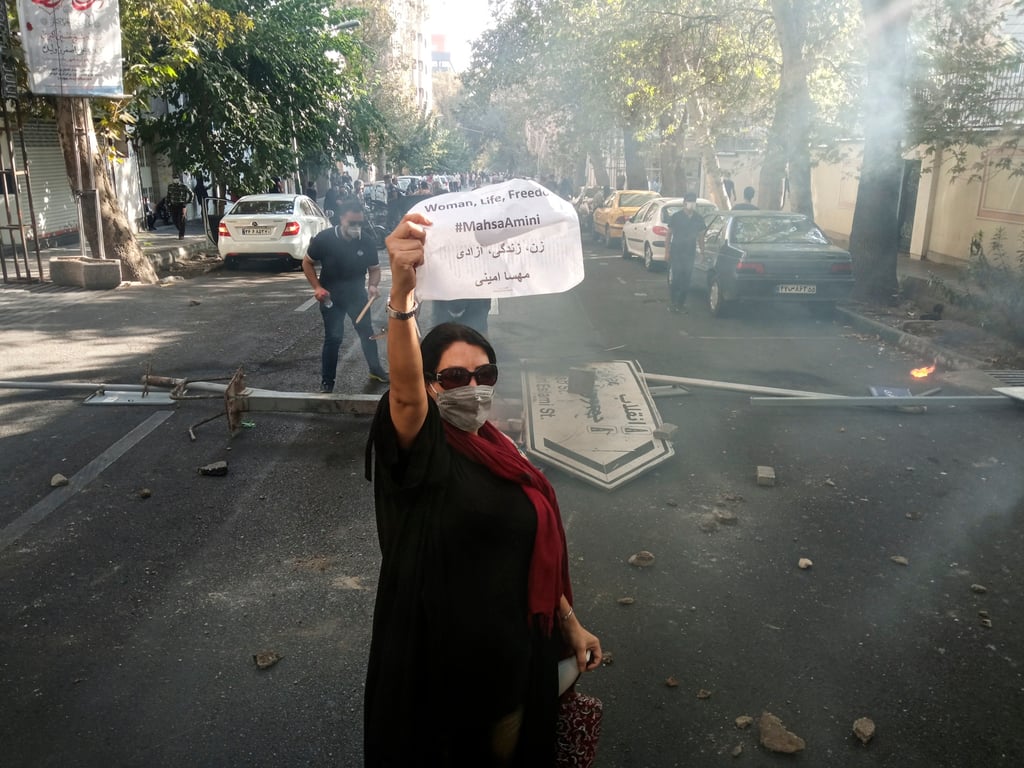 On October 1, 2022, in Tehran, a protester takes to the streets after the death of Mahsa Amini, a young woman who died after being arrested by Iran’s morality police. Photo: AP