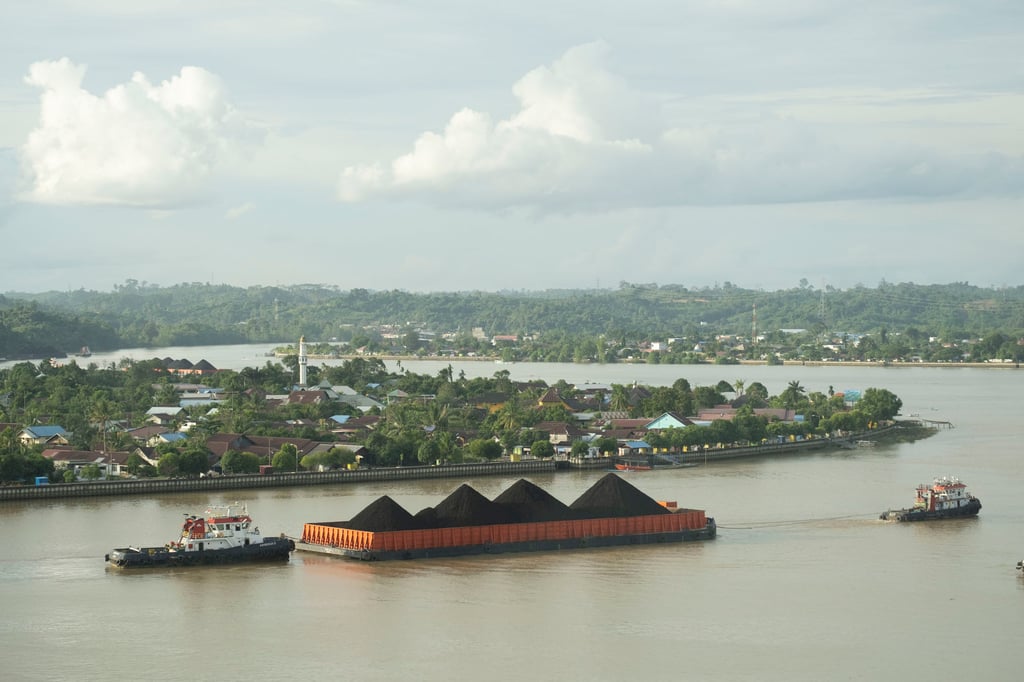 A coal barge sails along the Segai River. Photo: Oliver Raw