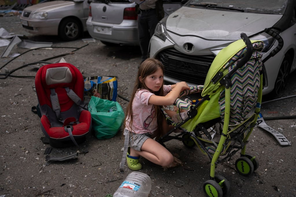 Polina, 10, looks after her sister Marina, 3, at the site of Okhmatdyt children’s hospital in Kyiv, which was hit by Russian missiles on Monday. Photo: AP
