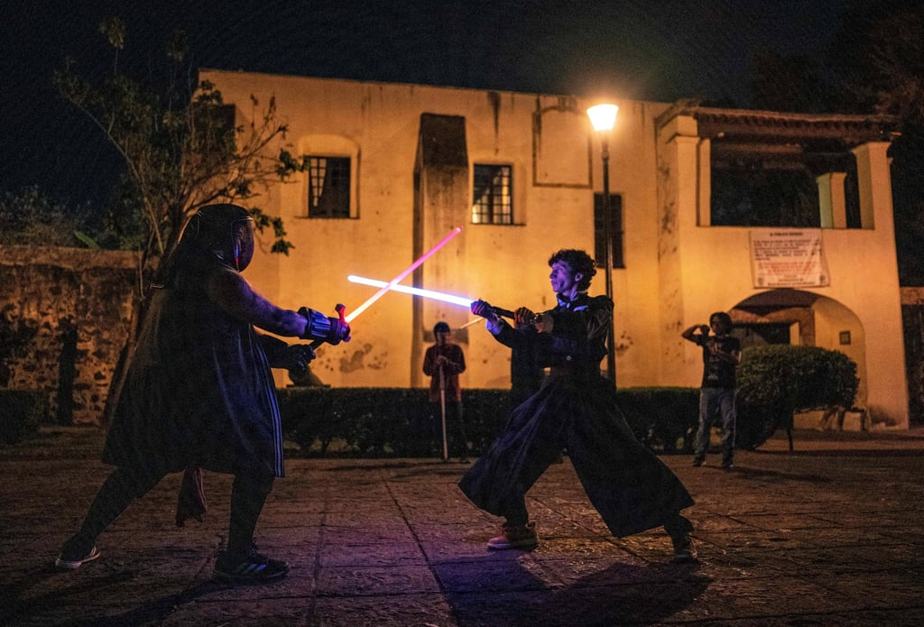 Members of the Jedi Knight Academy duel with lightsabers in Mexico City. Photo: AFP