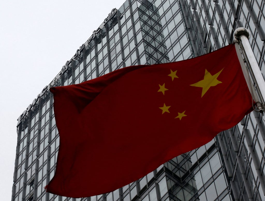 A building housing the PwC branch office is seen behind a Chinese national flag in Beijing. Photo: Reuters