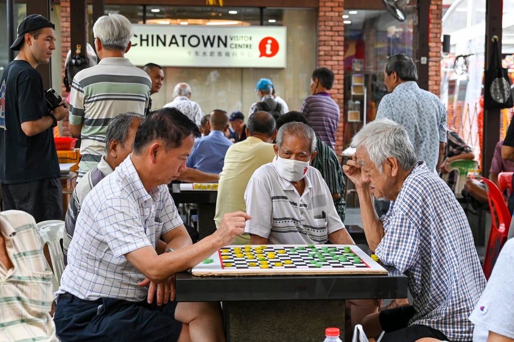 People play checkers game in Chinatown in Singapore on January 26. Building authentic and meaningful relationships grounded in shared interests, backgrounds and values is important. Photo: AFP