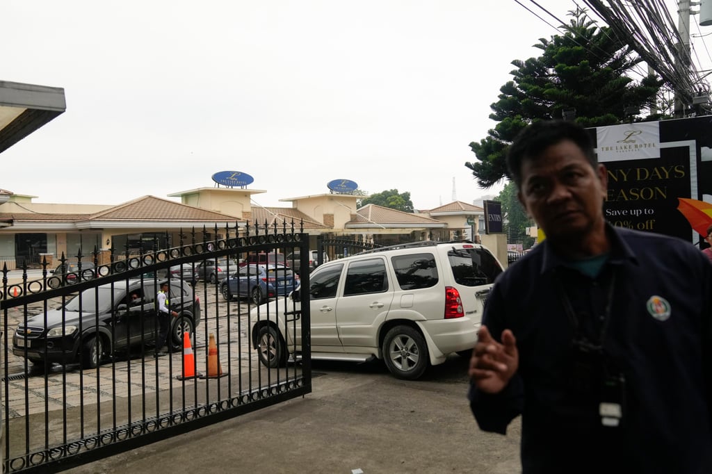 A security person tries to block a photographer outside the Lake Hotel in Tagaytay city. Photo: AP A security person tries to block a photographer outside the Lake Hotel in Tagaytay city. Photo: AP
