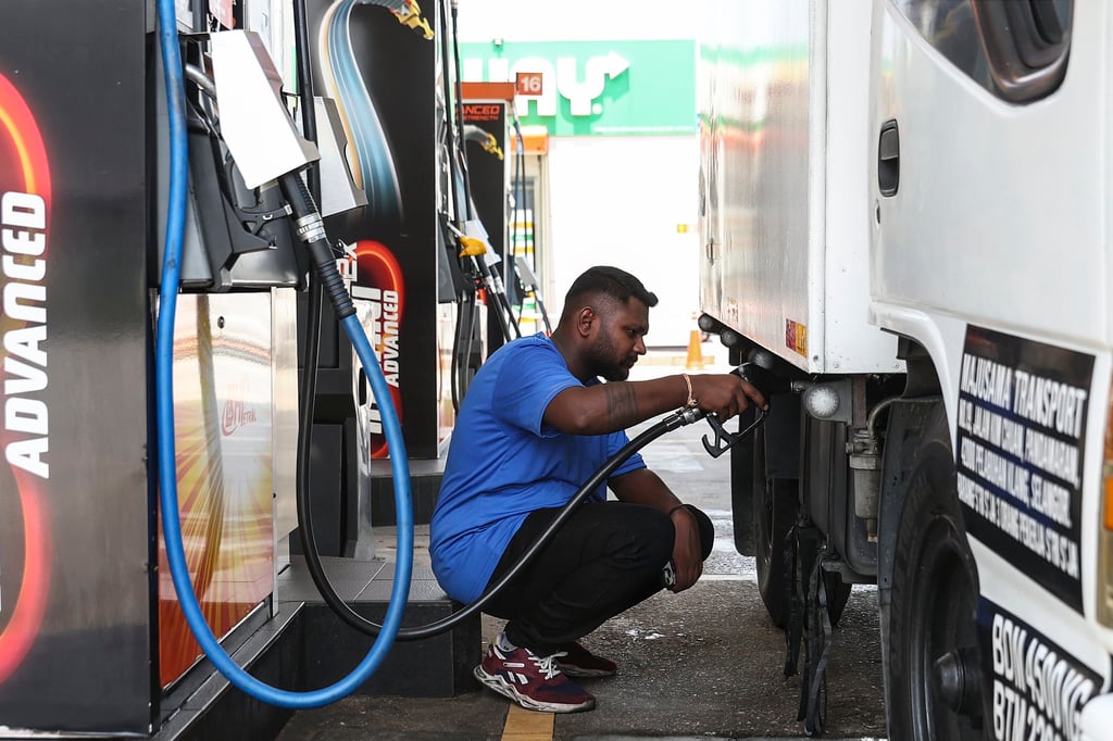 A man fills his vehicle with diesel at a fuelling station in Kuala Lumpur. Photo: EPA-EFE
