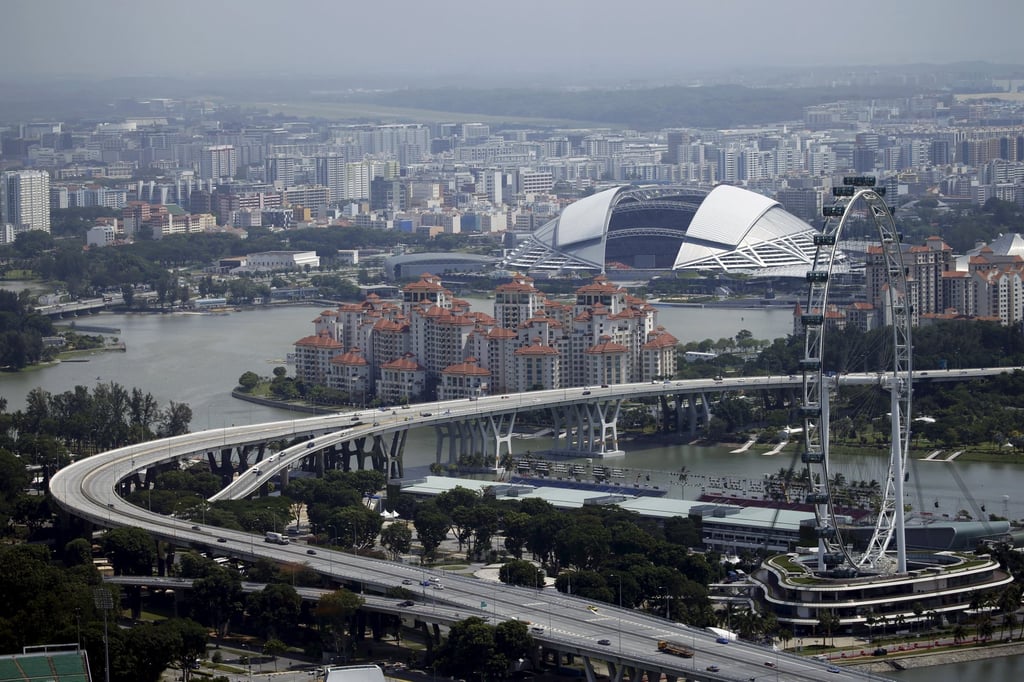 A view of the Singapore Flyer observatory wheel and the National Stadium among public and private residential apartments. Photo: Reuters