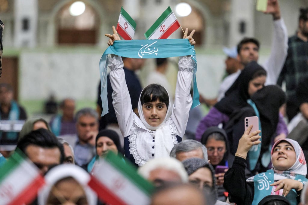 A girl holds up a scarf showing the name of Iran’s newly elected president Masoud Pezeshkian as he visits the shrine of the Islamic Republic’s founder Ayatollah Ruhollah Khomeini in Tehran on July 6. Photo: AFP