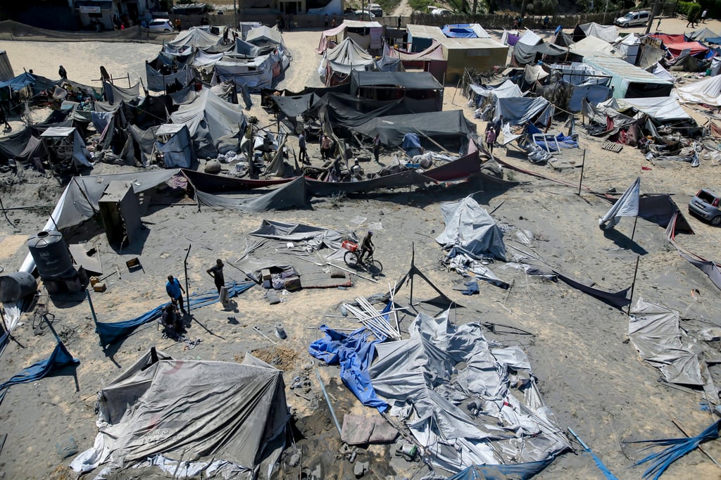 Palestinians inspect the damage at a site hit by an Israeli bombardment on Khan Younis. Photo: AP