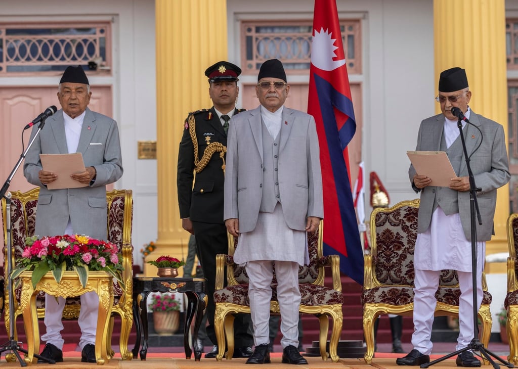 Nepal’s President Ram Chandra Paudel (left) administers the oath of office to newly elected Prime Minister Khadga Prasad Sharma Oli (right) while outgoing Prime Minister Puspha Kamal Dahal (middle) looks on during a ceremony at the presidential office in Kathmandu. Photo: EPA-EFE