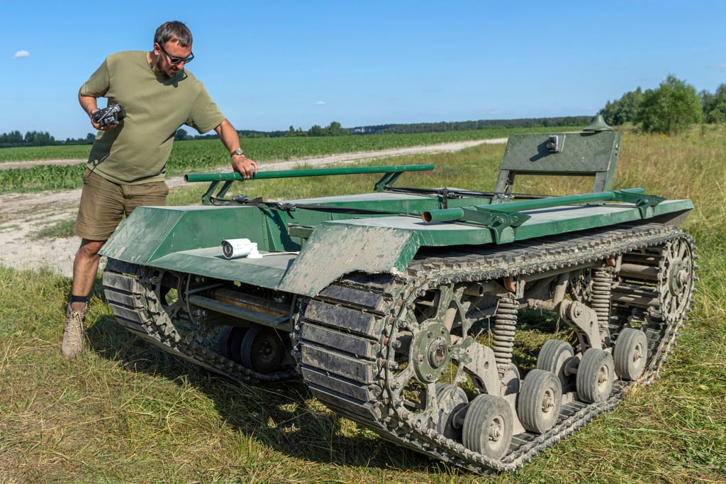 Andrii Denysenko, CEO of design and production bureau UkrPrototyp, stands by Odyssey, an 800kg ground drone prototype, at a corn field in northern Ukraine. Photo: AP