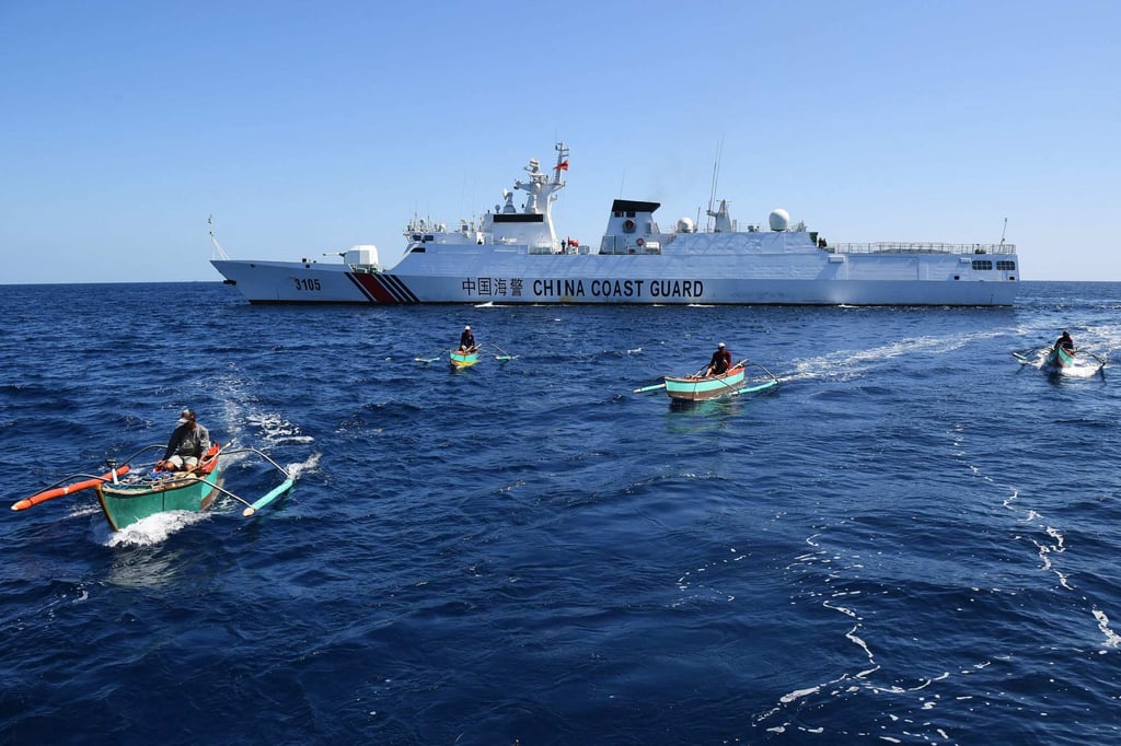 Filipino fishermen aboard their wooden boats sailing past a Chinese coast guard ship near the China-controlled Scarborough Shoal, in disputed waters of the South China Sea on February 15, 2024. Photo: AFP Filipino fishermen aboard their wooden boats sailing past a Chinese coast guard ship near the China-controlled Scarborough Shoal, in disputed waters of the South China Sea on February 15, 2024. Photo: AFP
