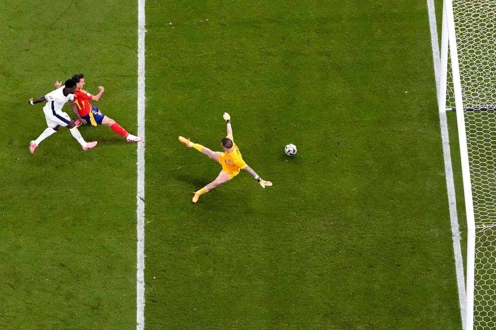 Spain’s Mikel Oyarzabal, centre, slides in his side’s second goal to overcome England in the Euro 2024 final. Photo: AP Spain’s Mikel Oyarzabal, centre, slides in his side’s second goal to overcome England in the Euro 2024 final. Photo: AP