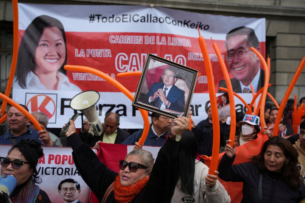 Supporters of Peru’s former president Alberto Fujimori and his daughter Keiko in Lima, Peru on Monday. Photo: AP