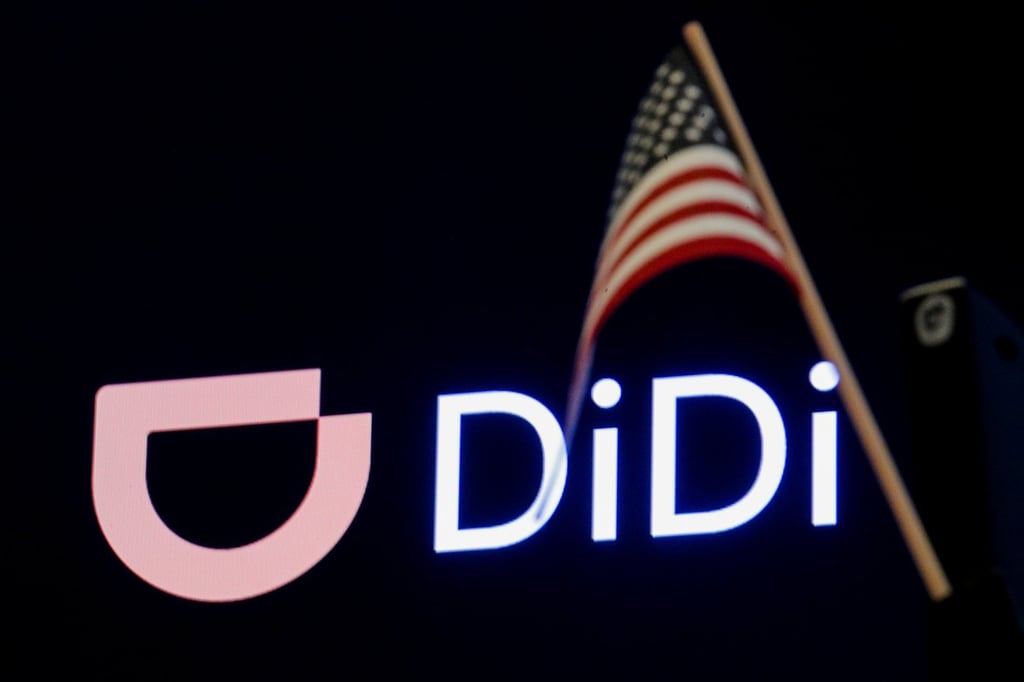 An American flag is seen in front of the logo for Chinese ride hailing company Didi during its IPO on the New York Stock Exchange, June 30, 2021. Photo: Reuters