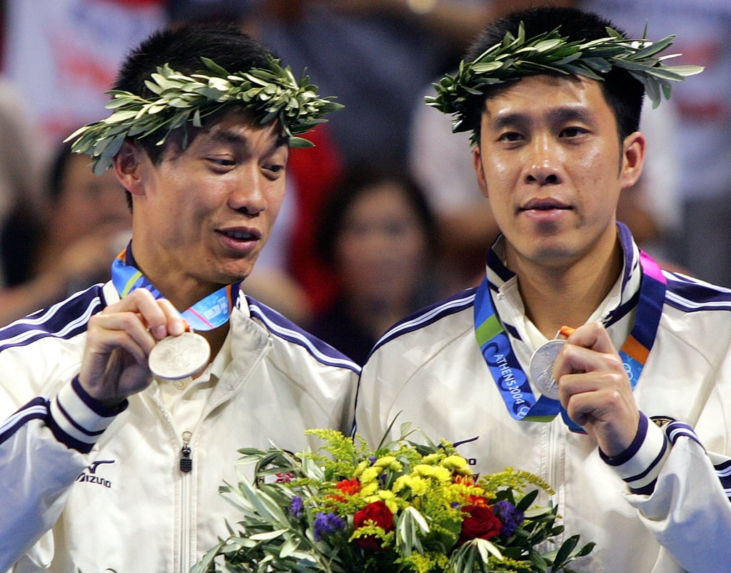 Li Ching (left) and Ko Lai-chak stand on the podium after defeat by China in the final in Athens. Photo: AP Li Ching (left) and Ko Lai-chak stand on the podium after defeat by China in the final in Athens. Photo: AP