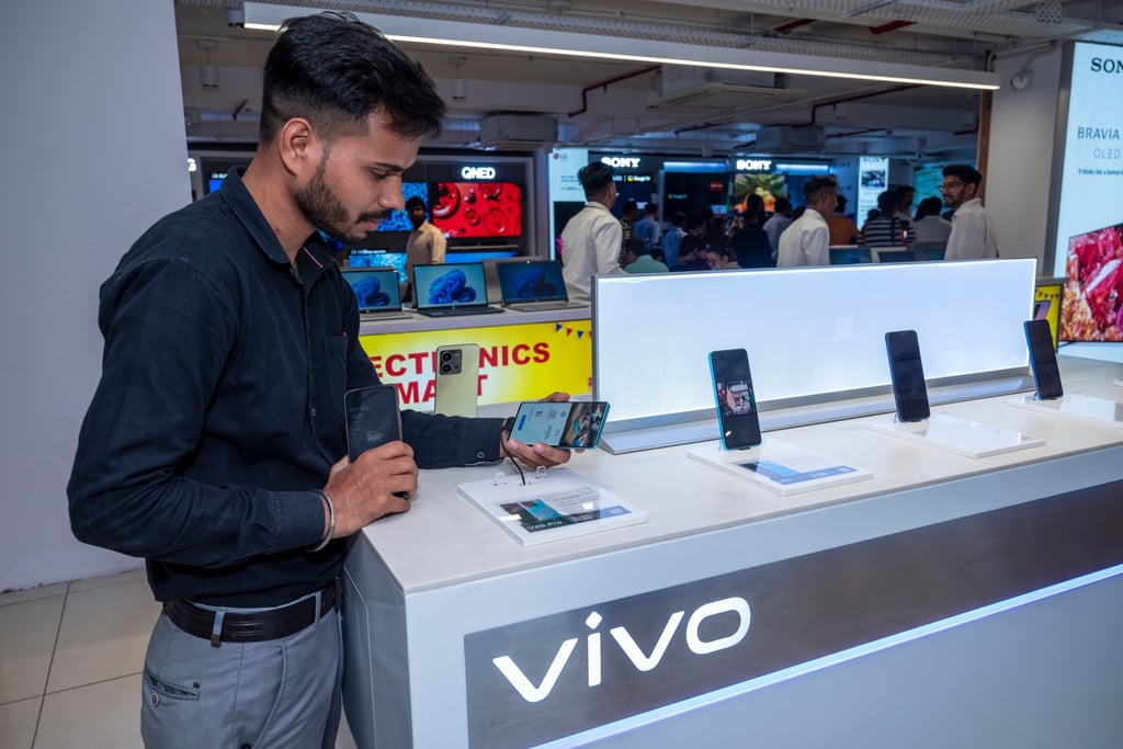 A customer looks at a Vivo smartphone in an electronics store in India. Photo: Shutterstock Images