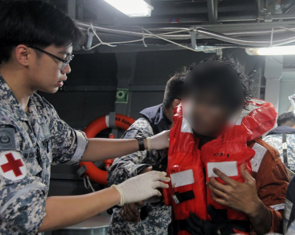 A medical team on board RSS Supreme providing help rescued crew from the oil tanker fire in the Singapore Strait on Friday. Photo: Facebook/SingaporeNavy
