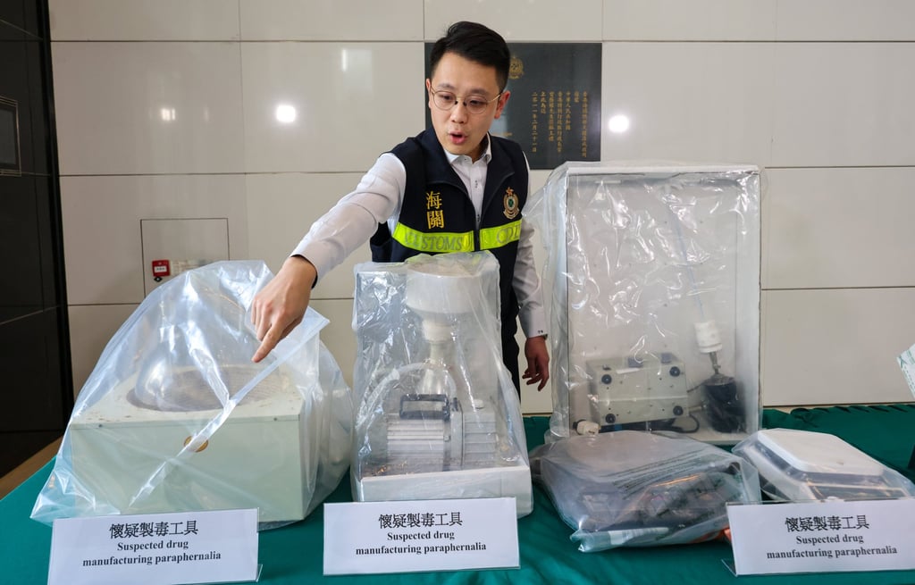 Senior inspector Tom Cheung of the customs drug investigation bureau shows media some of the seized equipment that investigators suspect was used to cook Ecstasy. Photo: Jelly Tse