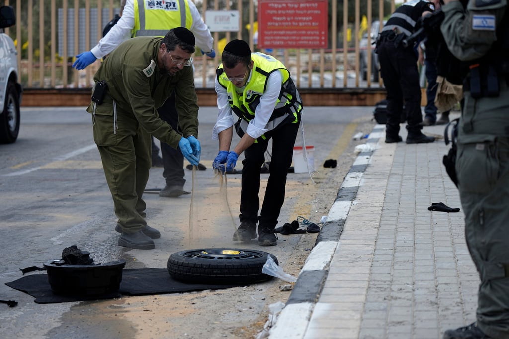 Israeli first responders investigate an attempted stabbing attack at the entrance to Netiv Haasara, north of the Gaza border in southern Israel on Monday. Photo: AP