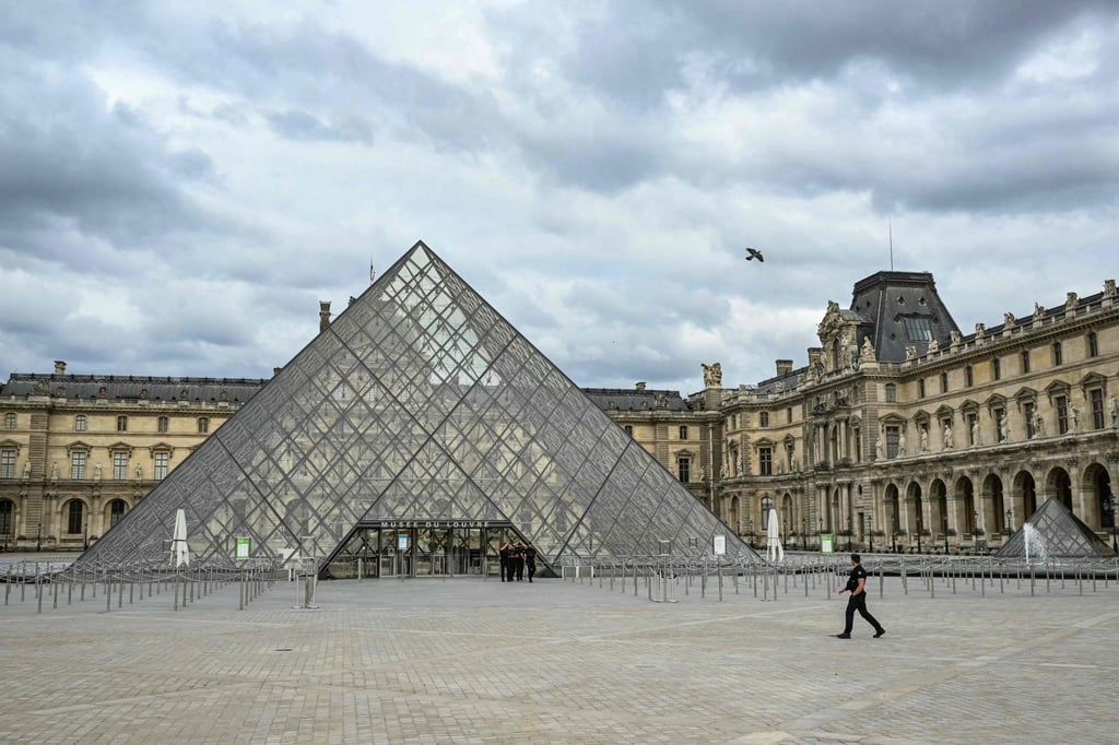French gendarmes patrol the IM Pei-designed Musee du Louvre and the Pyramide du Louvre. An average of 30,000 security guards will be deployed every day during the Games. Photo: AFP