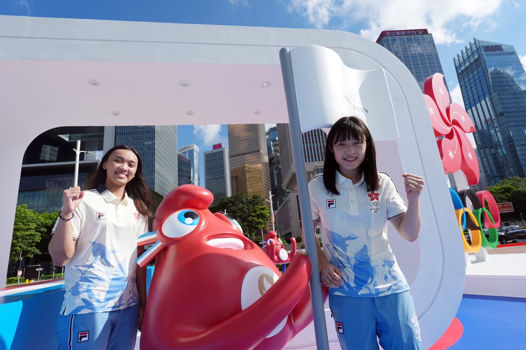 Hong Kong fencer Daphne Chan (left) and Judo athlete Wong Ka-lee pose for a picture at the Olympic-themed installation at Tamar Park in Admiralty before heading to Paris. Photo: Eugene Lee