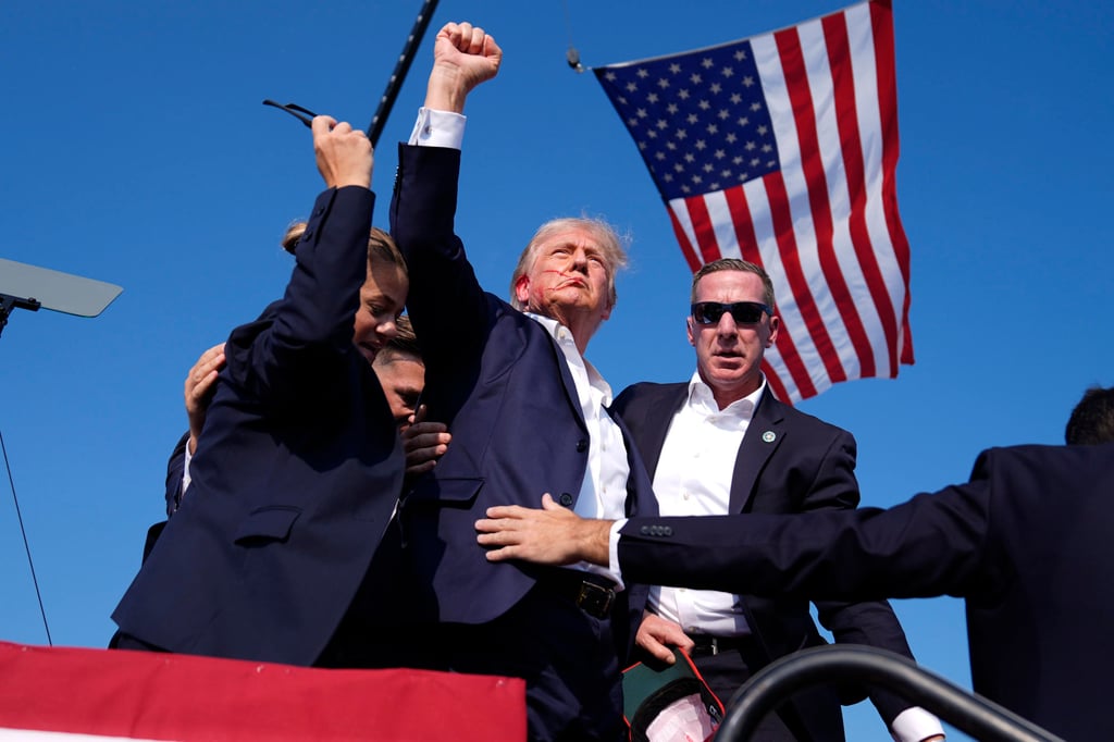 Donald Trump gestures surrounded by Secret Service agents as he leaves the stage following the shooting at a campaign rally in Pennsylvania. Photo: AP