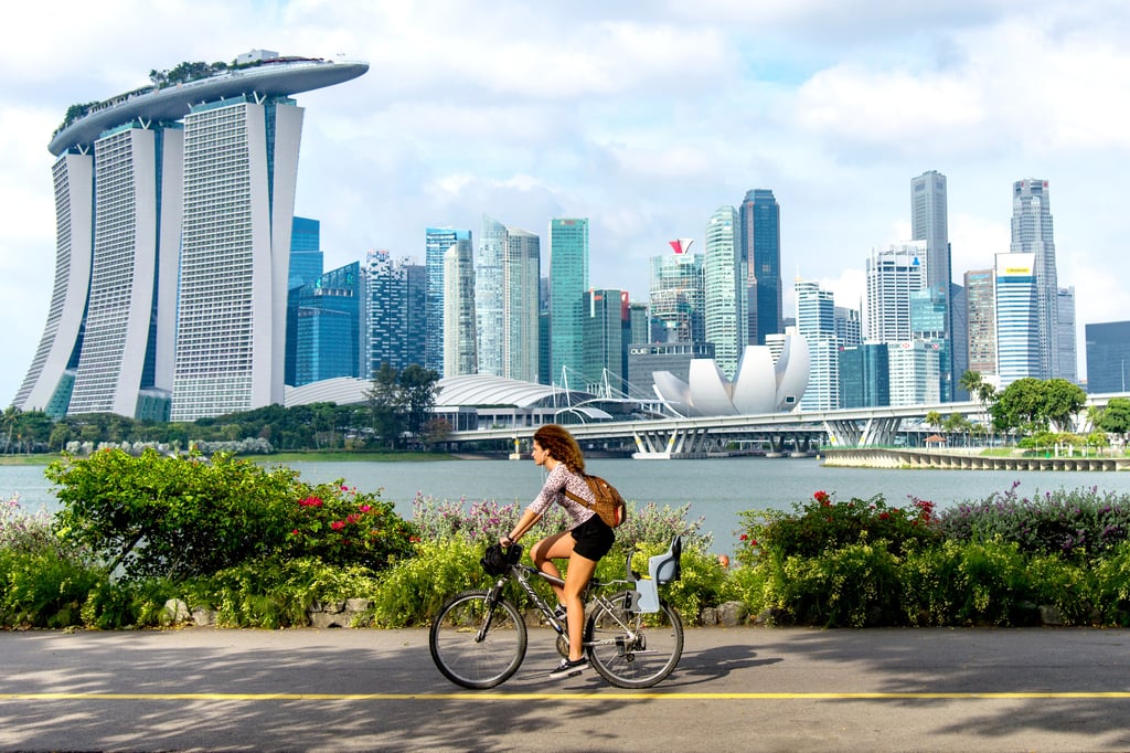 A cyclist in Singapore with the central business district in the background. Many visitors to Singapore go for the shopping and fancy restaurants with foreign chefs, but there’s more to the Lion City. Photo: Singapore Tourism Board