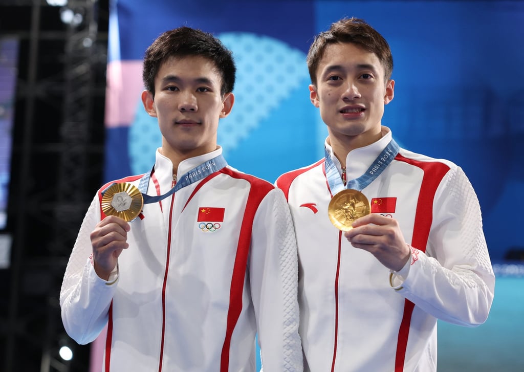 Yang Hao (left) and Lian Junjie of China won the gold in synchronised 10m platform event, upgrading their silver from Tokyo. Photo: Xinhua Yang Hao (left) and Lian Junjie of China won the gold in synchronised 10m platform event, upgrading their silver from Tokyo. Photo: Xinhua