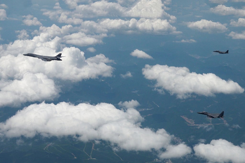 US Air Force B-1B bomber (left) and South Korean fighter jets F-15K fly over the Korean peninsula during joint aerial drills in June. Photo: South Korea Defence Ministry via AP