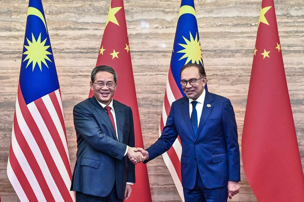 China’s Premier Li Qiang (left) shaking hands with Malaysia’s Prime Minister Anwar Ibrahim on June 19. Photo: Malaysia’s Department of Information/AFP