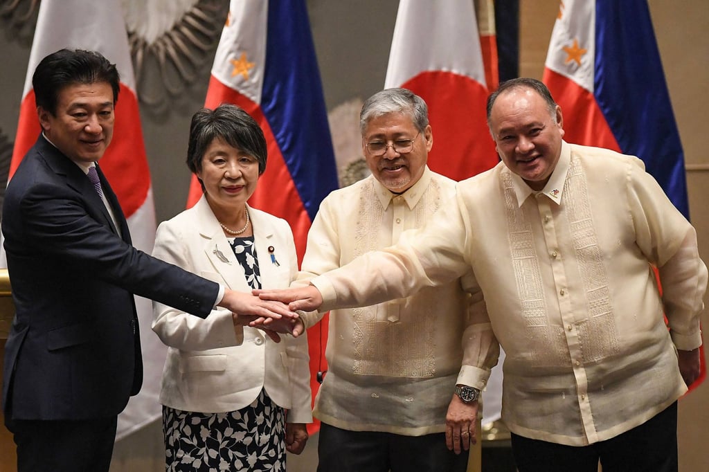 (From left) Japan’s Defence Minister Minoru Kihara and Foreign Minister Yoko Kamikawa, and the Philippines’ Secretary of Foreign Affairs Enrique Manalo and Secretary of Defence Gilberto Teodoro join hands after a meeting in Manila on July 8. Photo: AFP