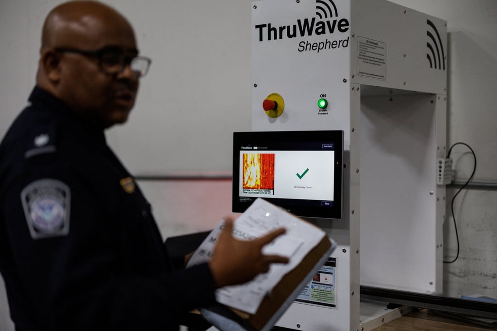 A US Customs and Border Protection agent stands next to a scanning machine at an air-cargo inspection warehouse near Los Angeles International Airport in California on May 2, 2024. Photo: Reuters