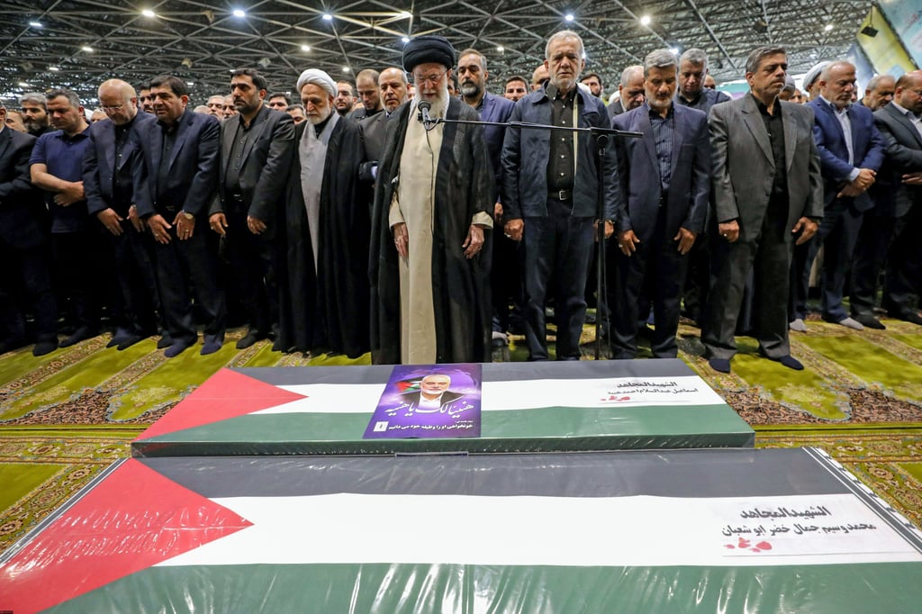 Iranian supreme leader Ayatollah Ali Khamenei, pictured with President Masoud Pezeshkian (centre right) at the Hamas leader’s funeral, has vowed revenge on Israel. Photo: AFP