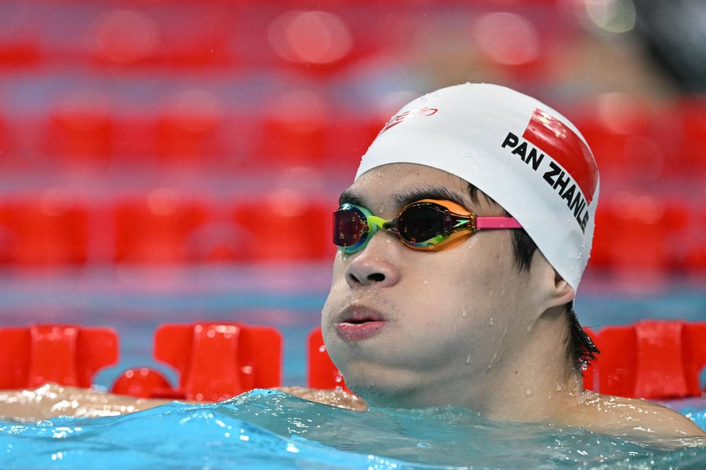 Pan Zhanle warms up before the race in which he broke the world record at the La Defense Arena. Photo: AFP Pan Zhanle warms up before the race in which he broke the world record at the La Defense Arena. Photo: AFP