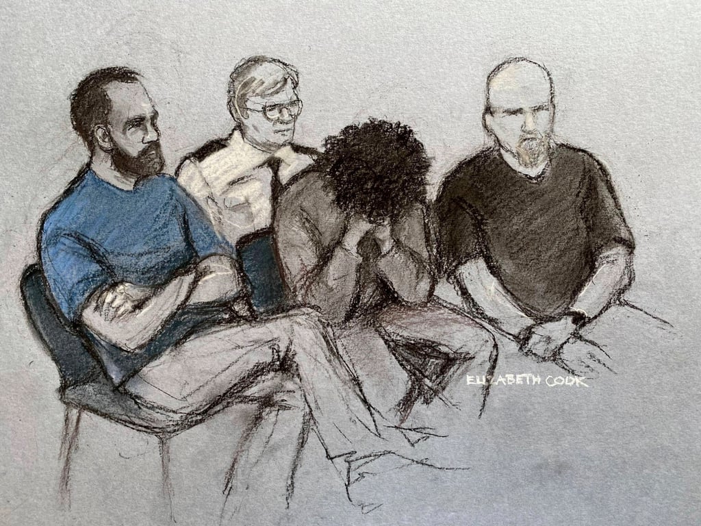 A court artist drawing shows 17-year-old Axel Rudakubana, centre, covering his face as he appears at Liverpool Crown Court in Liverpool, England on Thursday. Photo: PA via AP