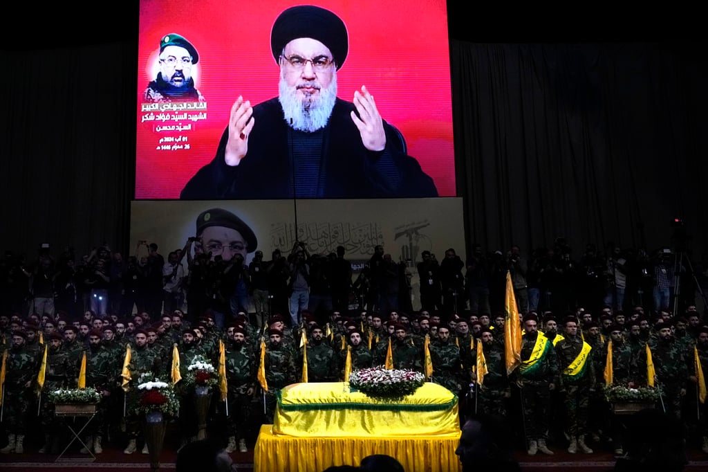 Hezbollah fighters stand behind the coffin of their top commander Fuad Shukr, who was killed by an Israeli air strike in Beirut, Lebanon. Photo: AP