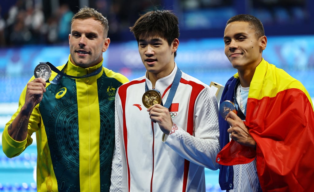 Gold medallist Pan Zhanle flanked by silver medallist Kyle Chalmers (left) and bronze medallist David Popovici. Photo: Reuters Gold medallist Pan Zhanle flanked by silver medallist Kyle Chalmers (left) and bronze medallist David Popovici. Photo: Reuters