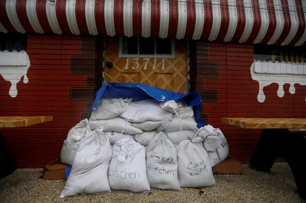 A closed store with sandbags placed in front of the entrance, in Madeira Beach, Florida. Photo: Reuters