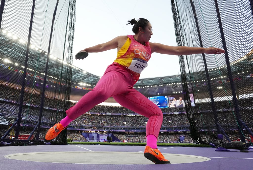 Bin Feng throws during the discus final at the Stade de France. Photo: Reuters Bin Feng throws during the discus final at the Stade de France. Photo: Reuters