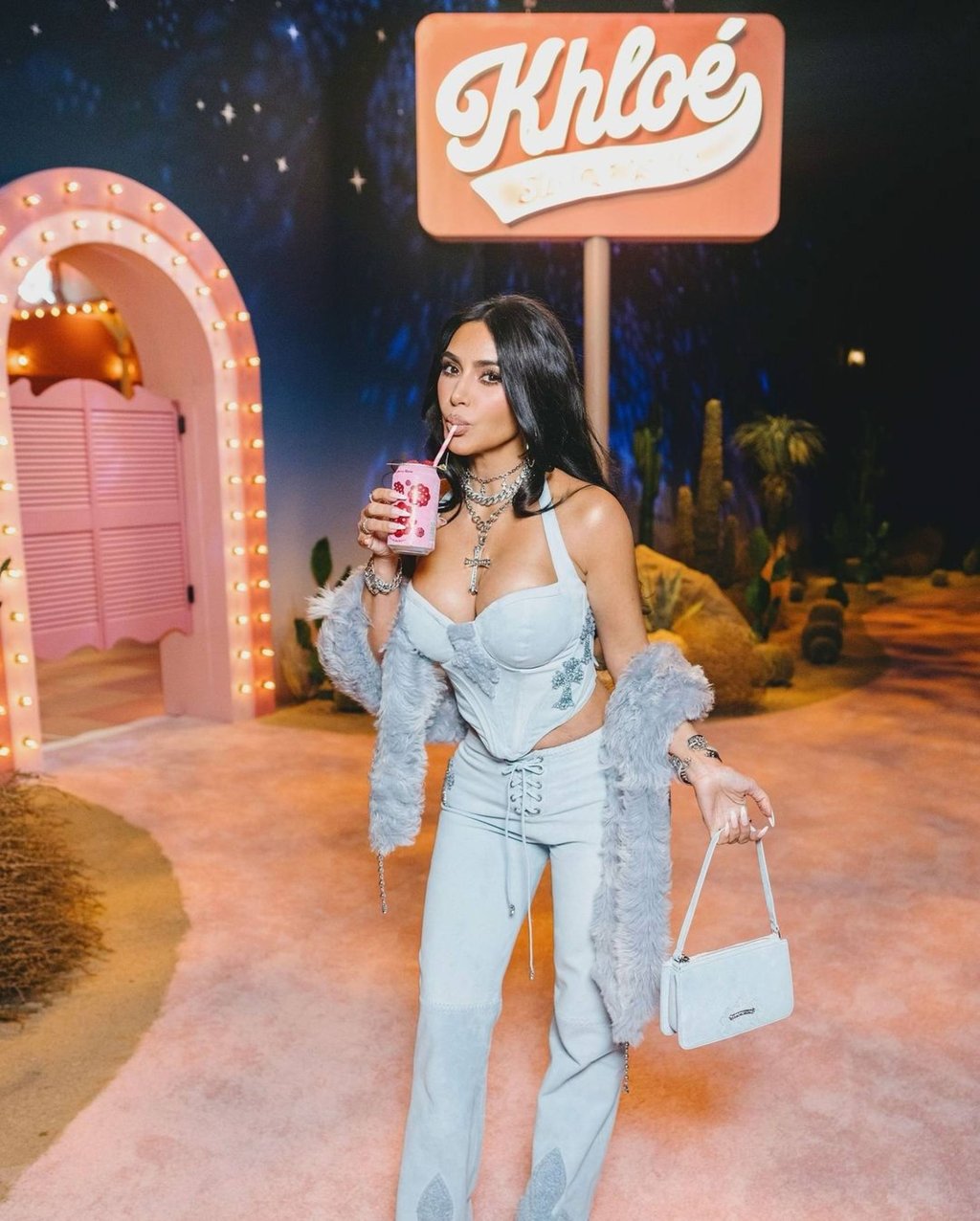 Kim Kardashian drinking a Poppi soft drink at sister Khloe’s birthday in June