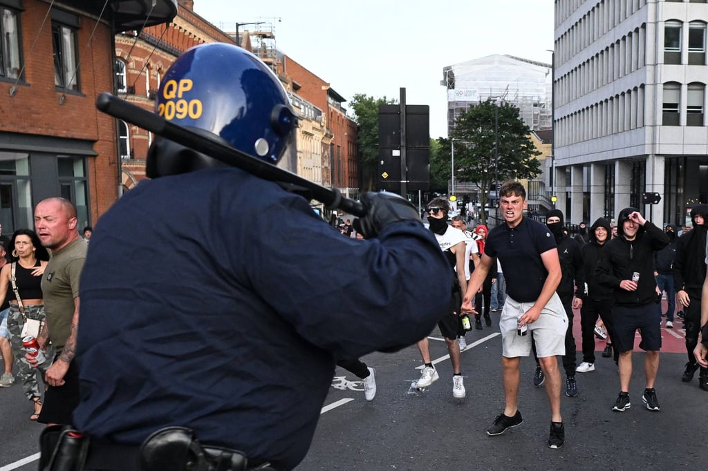 Riot police face protesters in Bristol. The unrest has prompted some Southeast Asian nations, including Muslim-majority Malaysia and Indonesia, to issue travel advisories. Photo: AFP