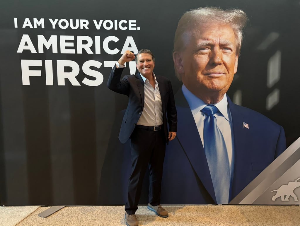 Ronny Jackson poses in front of one of Donald Trump’s campaign posters last month. Photo: @RonnyJacksonTX/X