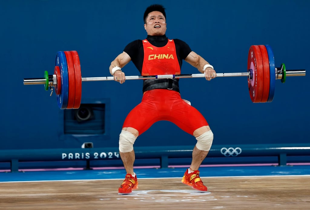 Li Fabin of China competes in the clean and jerk section of the weightlifting competition. Photo: EPA-EFE