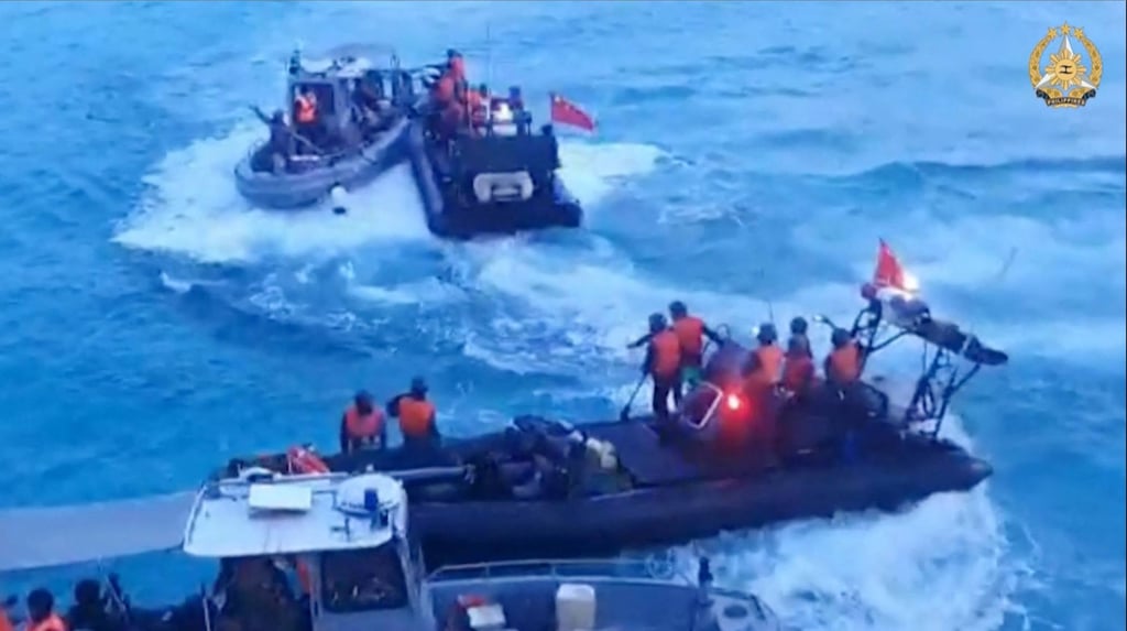 Chinese coastguard personnel confront Philippine Navy personnel near the Second Thomas Shoal in the South China Sea. Photo: AFP