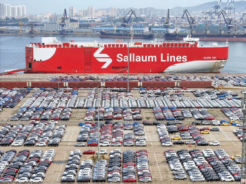 Cars await transport near a ship in Yantai in eastern China’s Shandong province on Tuesday. Photo: Chinatopix via AP