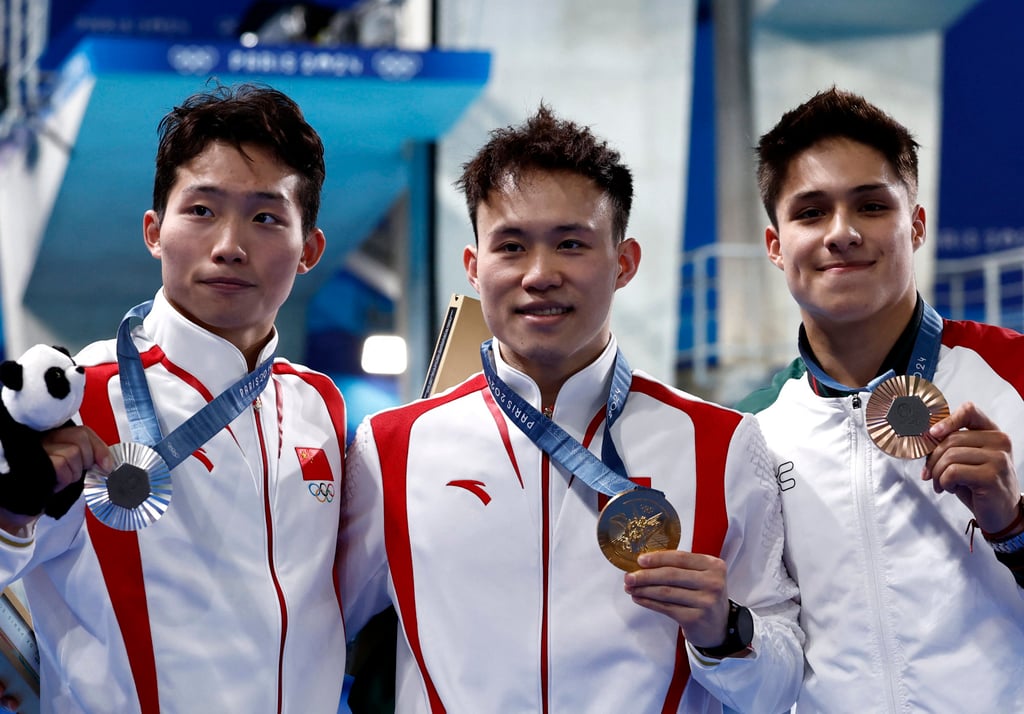 China’s gold medallist Xie Siyi (centre) celebrates after winning the men’s 3m springboard with silver medallist Wang Zongyuan (right) and bronze medallist Osmar Olvera. Photo: Reuters China’s gold medallist Xie Siyi (centre) celebrates after winning the men’s 3m springboard with silver medallist Wang Zongyuan (right) and bronze medallist Osmar Olvera. Photo: Reuters