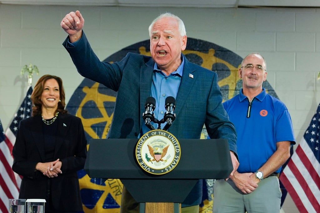 Minnesota Governor Tim Walz, with Democratic US presidential nominee Kamala Harris and Shawn Fain, President of the UAW, right, speaks at a campaign rally in Wayne, Michigan, on Thursday. Photo: AP