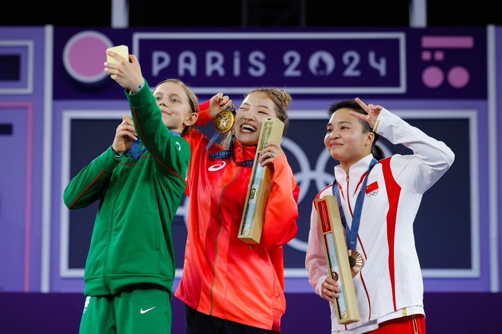Liu Qingyi (right) with her breaking bronze medal, alongside Lithuania’s silver-medallist Dominika Banevic (left) and Japan’s Yuasa Ami, who won gold. Photo: Xinhua