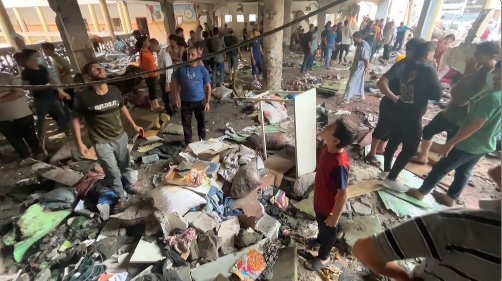 People inspect the damage at a school in Gaza City on Saturday after an Israeli air strike. Photo: AP People inspect the damage at a school in Gaza City on Saturday after an Israeli air strike. Photo: AP