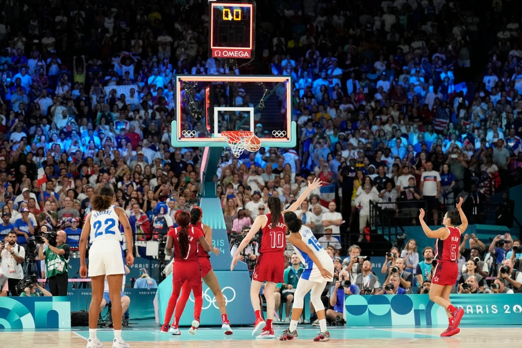 Gabby Williams (15) of France makes a basket as the clock hits zero in the women’s basketball final. Photo: AP Gabby Williams (15) of France makes a basket as the clock hits zero in the women’s basketball final. Photo: AP