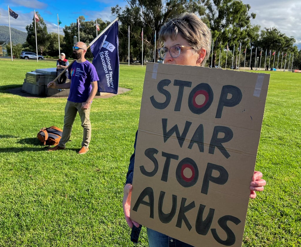 Anti-Aukus protesters stand outside Australia’s parliament in Canberra on March 18. Photo: Reuters